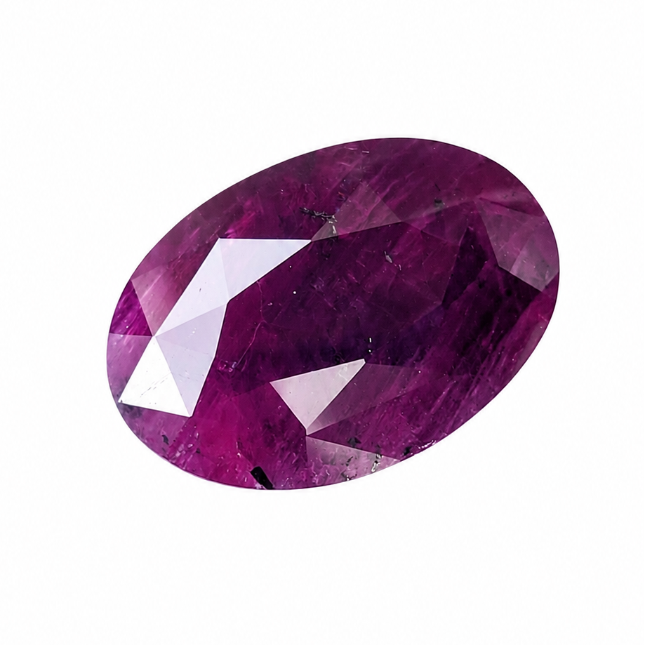 An oval-cut pinkish-purple gemstone with faceted edges, isolated on a solid white background.
