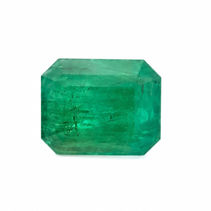 A single faceted emerald-cut green gemstone centered on a plain white background.