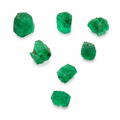 Seven raw emerald stones of various sizes arranged in a loose V-shape on a plain white background.