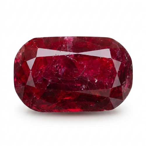 A cushion-cut, faceted ruby gemstone with deep red coloration and natural inclusions, displayed on a clean white background.