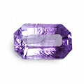 A single rectangular emerald-cut purple gemstone with a central channel cutout, displayed on a solid white background.