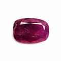 A single cushion-cut pinkish-red gemstone with a faceted finish, centered on a plain white background.