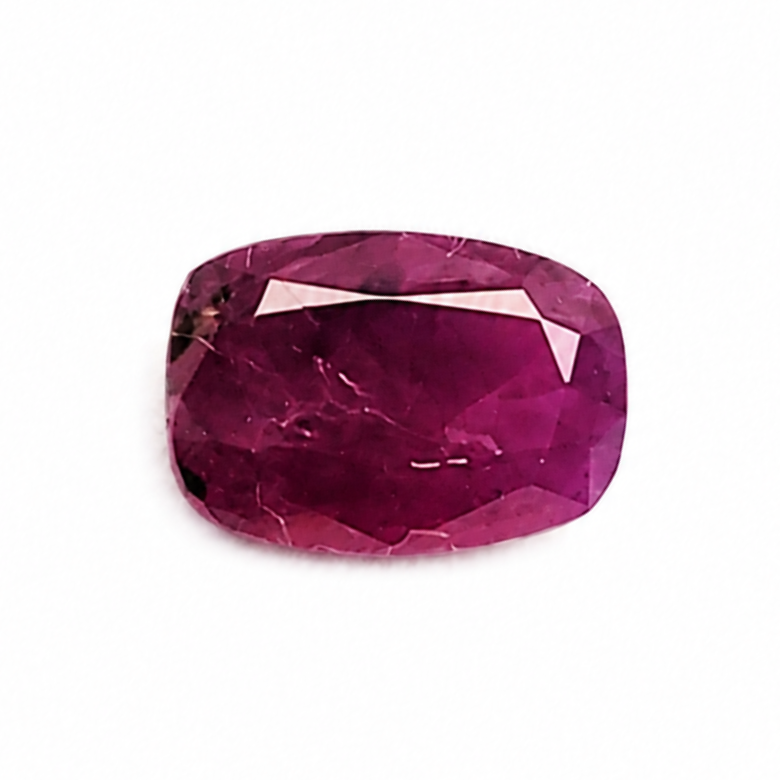 A single cushion-cut pinkish-red gemstone with a faceted finish, centered on a plain white background.