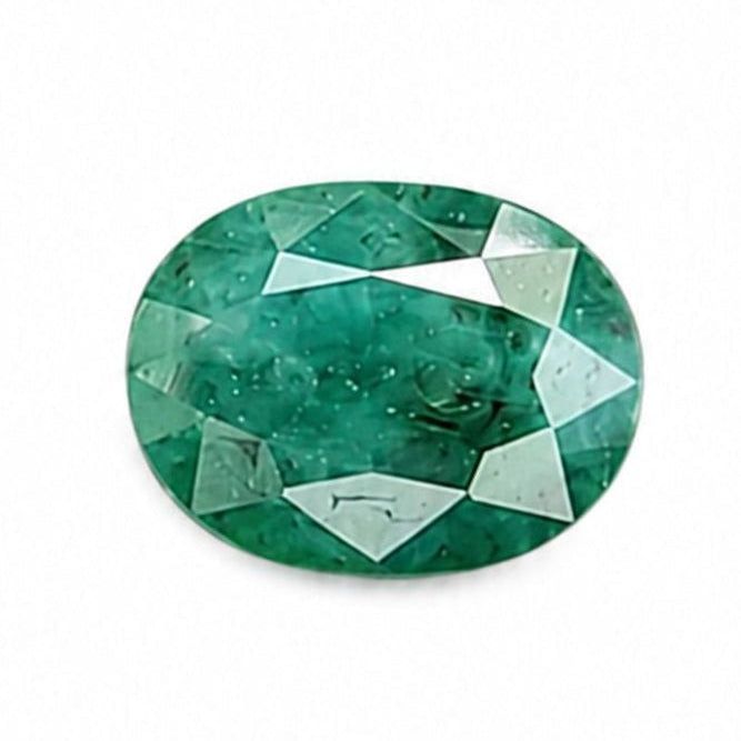 A faceted oval-cut green emerald gemstone centered on a plain white background.